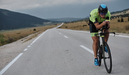 Image showing triathlon athlete riding bike