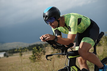 Image showing triathlon athlete riding bike