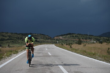 Image showing triathlon athlete riding bike