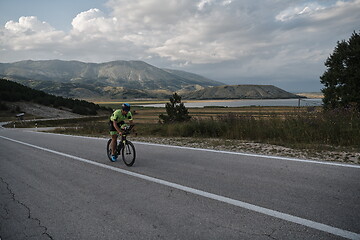 Image showing triathlon athlete riding bike