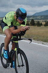 Image showing triathlon athlete riding bike