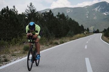 Image showing triathlon athlete riding bike