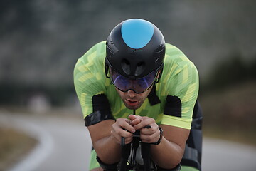 Image showing triathlon athlete riding bike