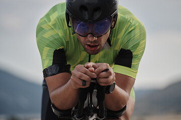 Image showing closeup of triathlon athlete riding bike