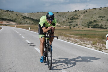 Image showing triathlon athlete riding bike