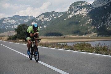 Image showing triathlon athlete riding bike