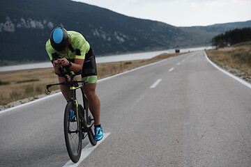 Image showing triathlon athlete riding bike