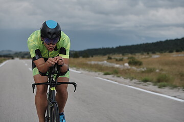 Image showing triathlon athlete riding bike