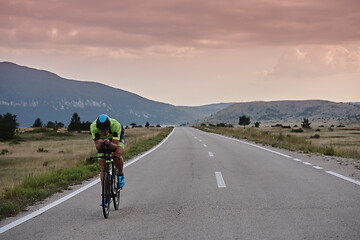 Image showing triathlon athlete riding bike