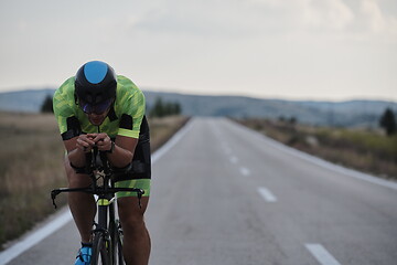 Image showing triathlon athlete riding bike