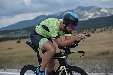 Image showing triathlon athlete riding bike