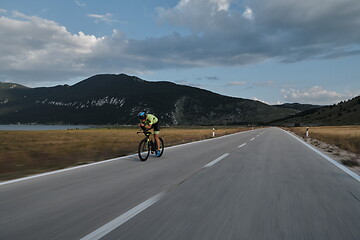 Image showing triathlon athlete riding bike