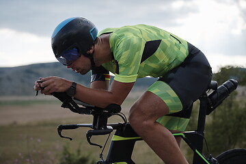 Image showing triathlon athlete riding bike