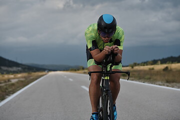 Image showing triathlon athlete riding bike