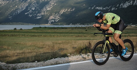 Image showing triathlon athlete riding bike