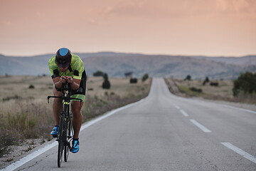 Image showing triathlon athlete riding bike