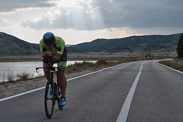 Image showing triathlon athlete riding bike