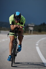 Image showing triathlon athlete riding bike