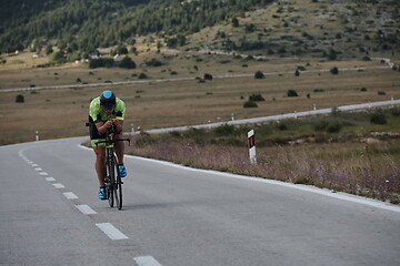 Image showing triathlon athlete riding bike