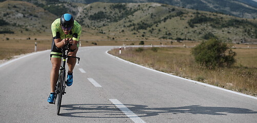 Image showing triathlon athlete riding bike