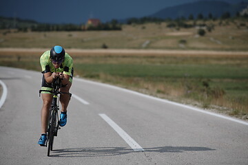 Image showing triathlon athlete riding bike