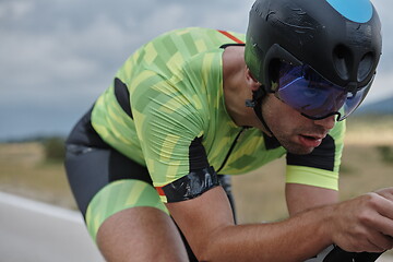 Image showing triathlon athlete riding bike