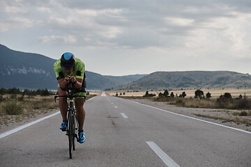 Image showing triathlon athlete riding bike