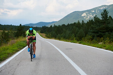 Image showing triathlon athlete riding bike