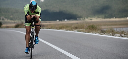 Image showing triathlon athlete riding bike