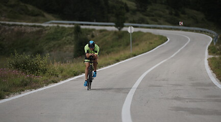 Image showing triathlon athlete riding bike