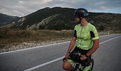 Image showing triathlon athlete riding bike