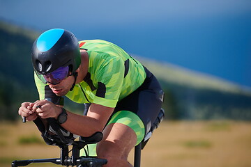 Image showing triathlon athlete riding bike