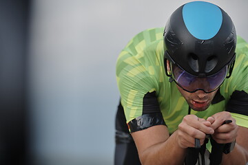 Image showing triathlon athlete riding bike