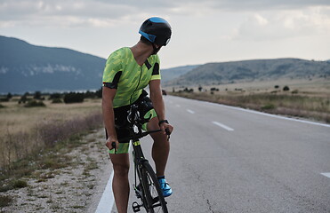 Image showing triathlon athlete riding bike