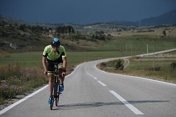 Image showing triathlon athlete riding bike