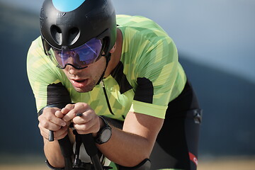 Image showing triathlon athlete riding bike