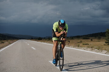 Image showing triathlon athlete riding bike