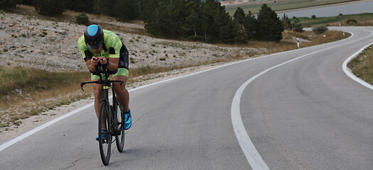 Image showing triathlon athlete riding bike