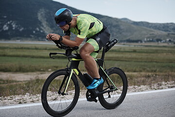 Image showing triathlon athlete riding bike