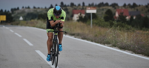 Image showing triathlon athlete riding bike