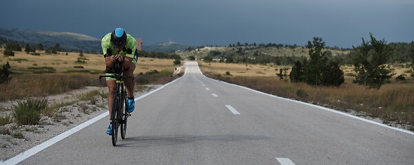 Image showing triathlon athlete riding bike