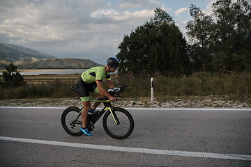 Image showing triathlon athlete riding bike