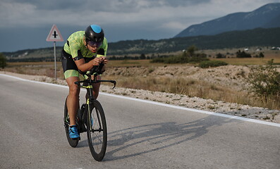 Image showing triathlon athlete riding bike