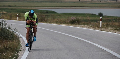 Image showing triathlon athlete riding bike