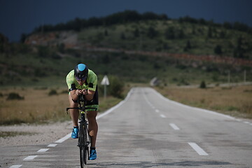 Image showing triathlon athlete riding bike