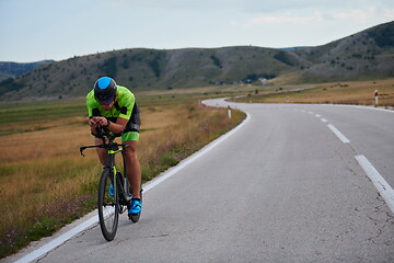 Image showing triathlon athlete riding bike