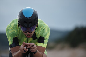 Image showing triathlon athlete riding bike