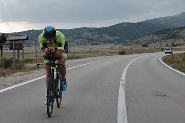 Image showing triathlon athlete riding bike