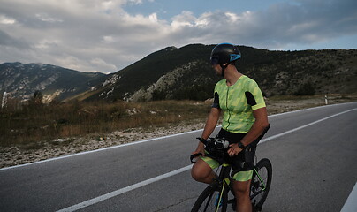 Image showing triathlon athlete riding bike