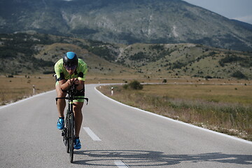 Image showing triathlon athlete riding bike